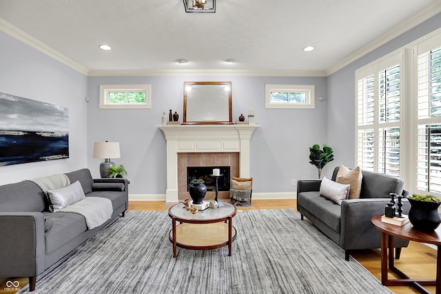 2263 Glebe St, Carmel, IN 46032 - living area featuring light wood-style flooring, plenty of natural light, ornamental molding, a tile fireplace, and recessed lighting