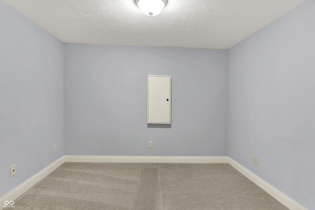 2263 Glebe St, Carmel, IN 46032 - carpeted empty room with a textured ceiling