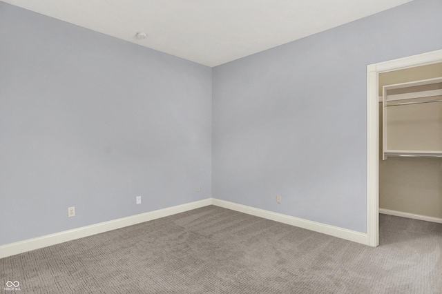 2263 Glebe St, Carmel, IN 46032 - unfurnished bedroom with carpet flooring, a walk in closet, and a closet