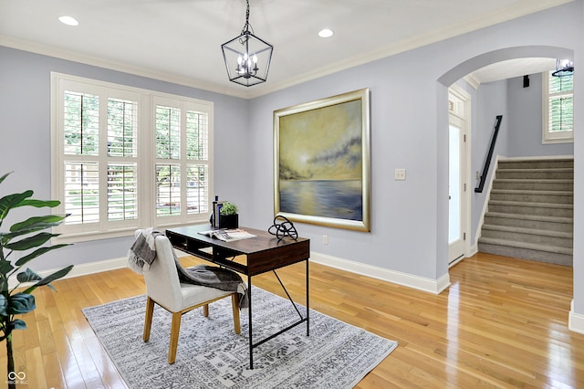 2263 Glebe St, Carmel, IN 46032 - office area featuring plenty of natural light, crown molding, arched walkways, light wood finished floors, and a chandelier