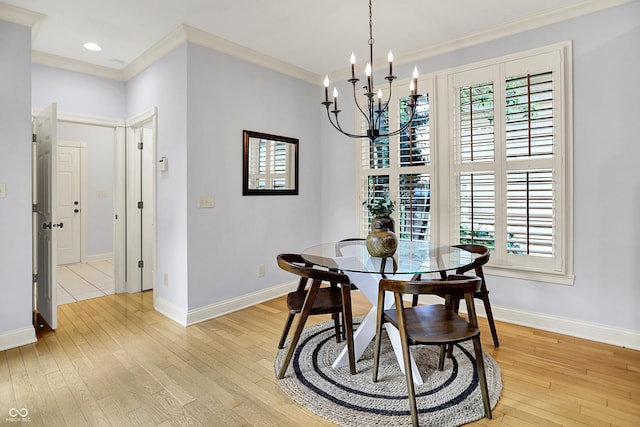 2263 Glebe St, Carmel, IN 46032 - dining area featuring crown molding, a chandelier, light wood finished floors, plenty of natural light, and recessed lighting