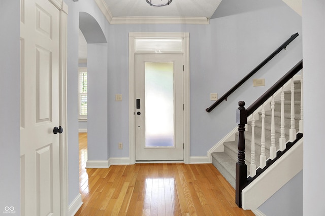 2263 Glebe St, Carmel, IN 46032 - entrance foyer featuring light wood-type flooring, arched walkways, stairway, and crown molding