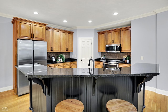2263 Glebe St, Carmel, IN 46032 - kitchen with appliances with stainless steel finishes, brown cabinets, light wood-type flooring, recessed lighting, and ornamental molding