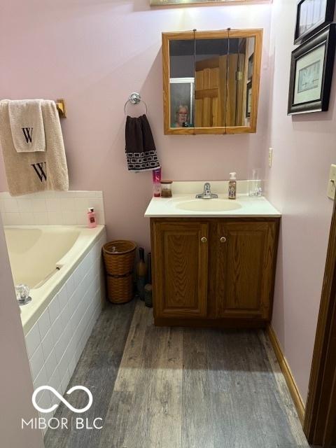 18 Hough St, Greenfield, IN 46140 - full bath featuring wood finished floors, vanity, and a garden tub