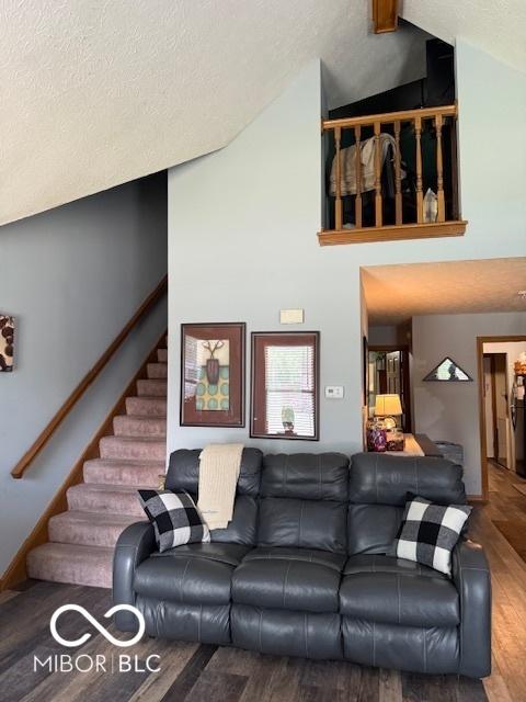 18 Hough St, Greenfield, IN 46140 - living area with vaulted ceiling, wood finished floors, a textured ceiling, and stairway