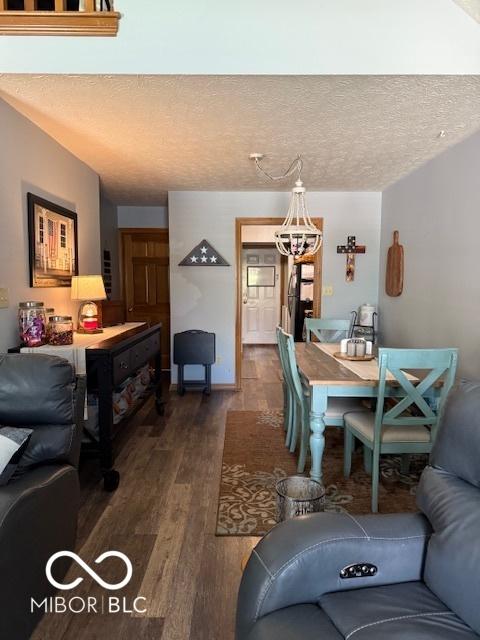 18 Hough St, Greenfield, IN 46140 - dining space featuring a chandelier, dark wood finished floors, and a textured ceiling