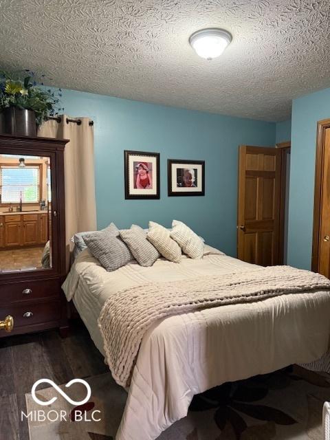 18 Hough St, Greenfield, IN 46140 - bedroom with dark wood-type flooring and a textured ceiling