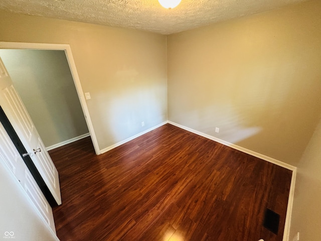 1345 S Biltmore Ave, Indianapolis, IN 46241 - unfurnished room with dark wood finished floors and a textured ceiling