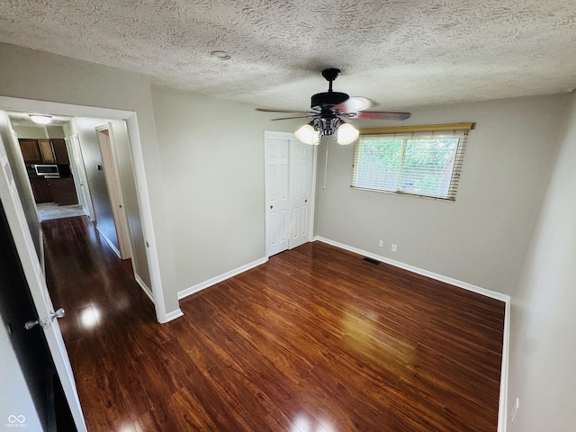 1345 S Biltmore Ave, Indianapolis, IN 46241 - unfurnished bedroom with wood finished floors, a closet, a textured ceiling, and a ceiling fan