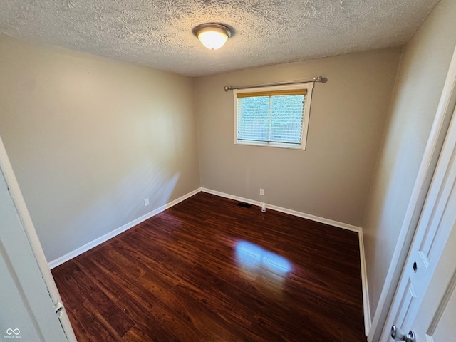 1345 S Biltmore Ave, Indianapolis, IN 46241 - empty room with dark wood-style floors and a textured ceiling