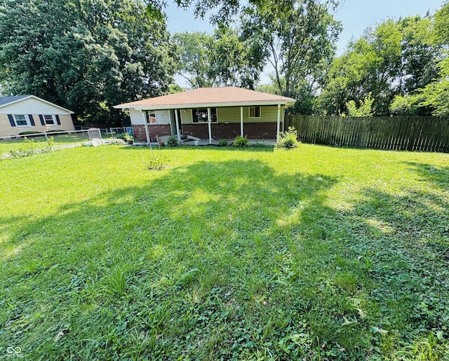 1345 S Biltmore Ave, Indianapolis, IN 46241 - fenced backyard with covered porch