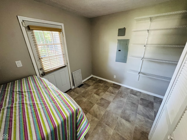 1345 S Biltmore Ave, Indianapolis, IN 46241 - bedroom featuring electric panel and a textured ceiling