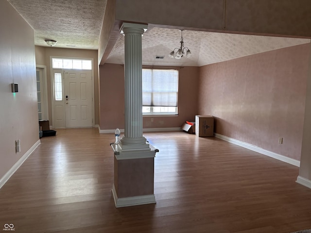 2929 Tuscarora Ln, Indianapolis, IN 46217 - entryway featuring ornate columns, wood finished floors, healthy amount of natural light, and a chandelier