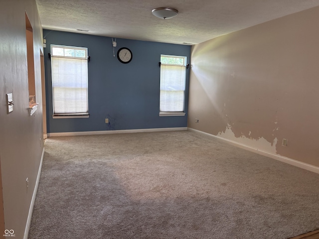 2929 Tuscarora Ln, Indianapolis, IN 46217 - carpeted empty room with a textured ceiling and healthy amount of natural light
