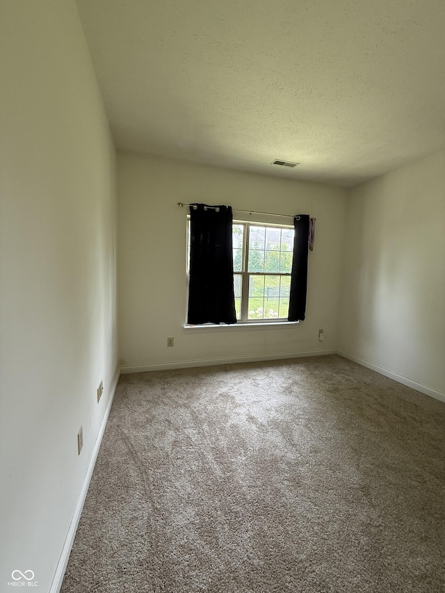2929 Tuscarora Ln, Indianapolis, IN 46217 - carpeted empty room featuring baseboards and a textured ceiling