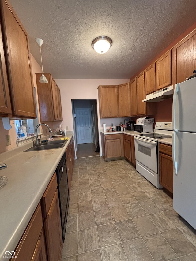 2929 Tuscarora Ln, Indianapolis, IN 46217 - kitchen featuring white appliances, under cabinet range hood, brown cabinetry, light countertops, and a textured ceiling