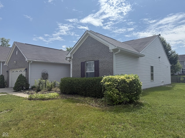 2929 Tuscarora Ln, Indianapolis, IN 46217 - view of side of home with a garage, a yard, brick siding, and a shingled roof