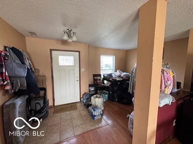 2230 Cedarmill Dr, Franklin, IN 46131 - foyer entrance with a textured ceiling and wood finished floors