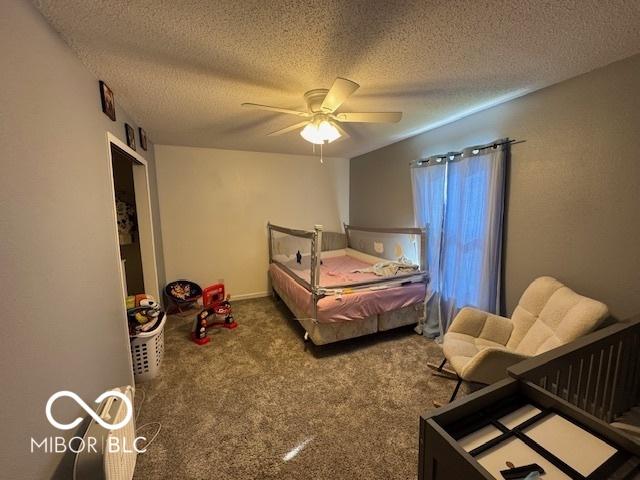 2230 Cedarmill Dr, Franklin, IN 46131 - bedroom featuring carpet floors, a textured ceiling, and ceiling fan