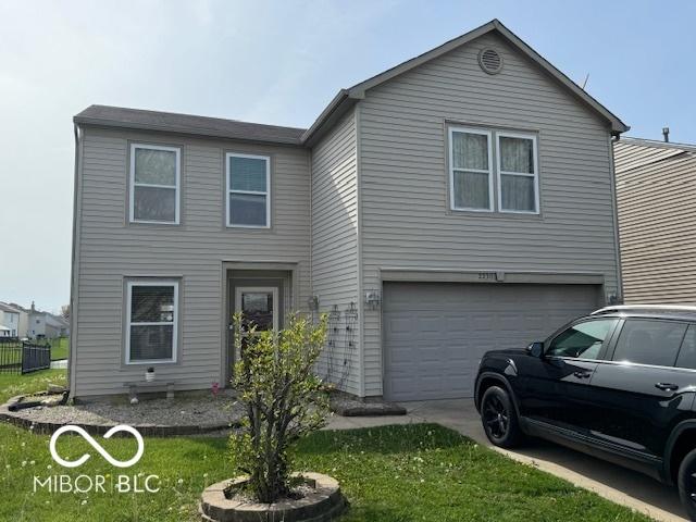 2230 Cedarmill Dr, Franklin, IN 46131 - view of front of home featuring an attached garage, driveway, and a front lawn