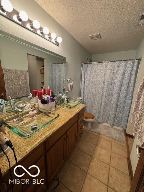 2230 Cedarmill Dr, Franklin, IN 46131 - bathroom featuring vanity, a textured ceiling, and tile patterned flooring