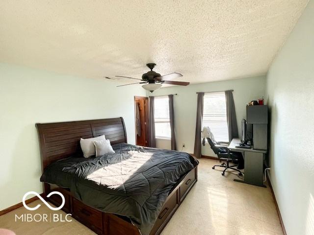 2230 Cedarmill Dr, Franklin, IN 46131 - bedroom with a textured ceiling, ceiling fan, and light carpet