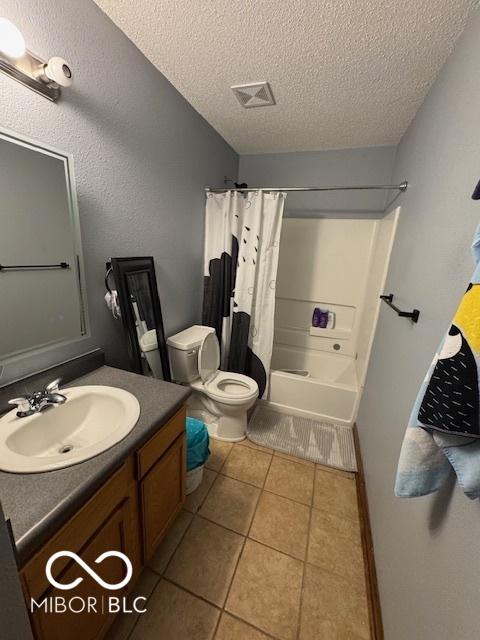 2230 Cedarmill Dr, Franklin, IN 46131 - bathroom featuring a textured ceiling, vanity, tile patterned floors, and shower / tub combo