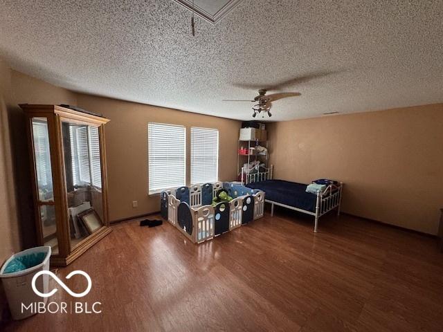 2230 Cedarmill Dr, Franklin, IN 46131 - bedroom with wood finished floors, a textured ceiling, attic access, and ceiling fan