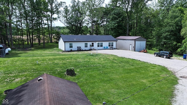 9191 W Mt Carmel Rd, Gosport, IN 47433 - view of front facade with a front yard, driveway, and an outbuilding