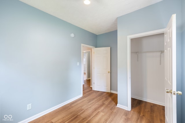 615 Udell St, Indianapolis, IN 46208 - unfurnished bedroom featuring wood finished floors and a closet