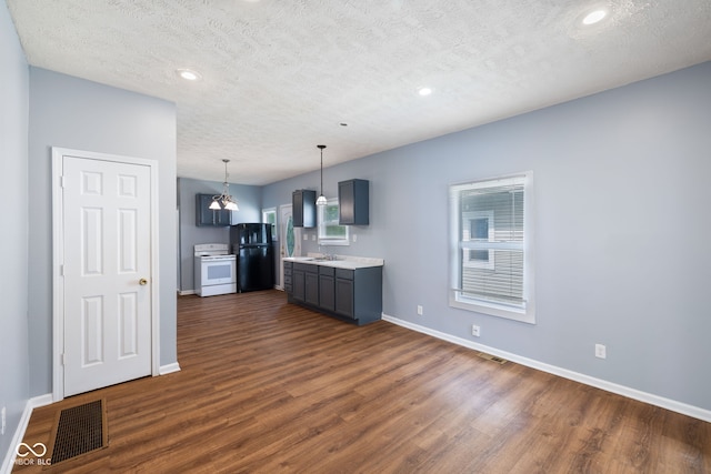 615 Udell St, Indianapolis, IN 46208 - kitchen with white electric stove, dark wood finished floors, light countertops, a textured ceiling, and recessed lighting