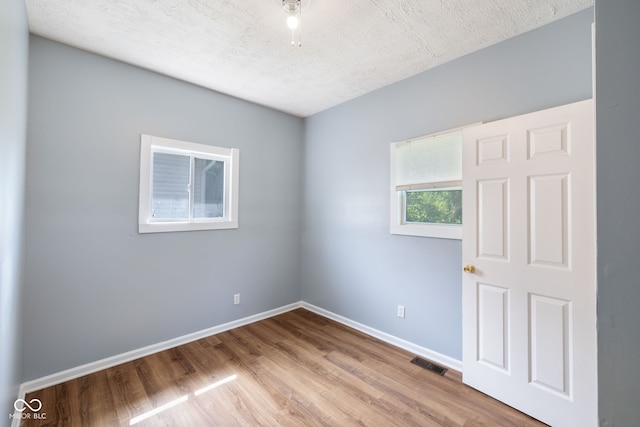 615 Udell St, Indianapolis, IN 46208 - spare room featuring a textured ceiling and wood finished floors