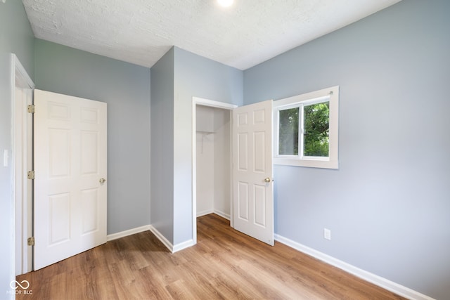 615 Udell St, Indianapolis, IN 46208 - unfurnished bedroom featuring light wood-style flooring and baseboards