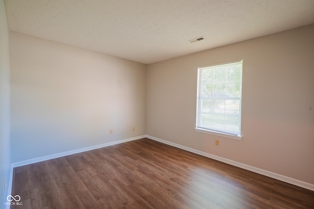 6029 Sycamore Forge Dr, Indianapolis, IN 46254 - empty room with dark wood-style flooring and a textured ceiling