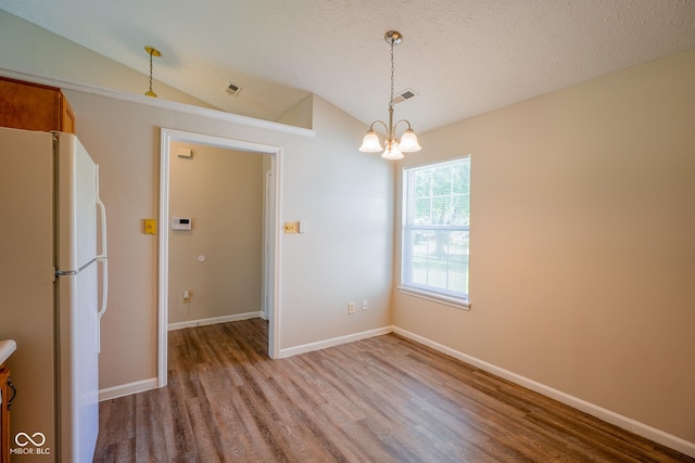 6029 Sycamore Forge Dr, Indianapolis, IN 46254 - unfurnished dining area featuring lofted ceiling, wood finished floors, and a chandelier
