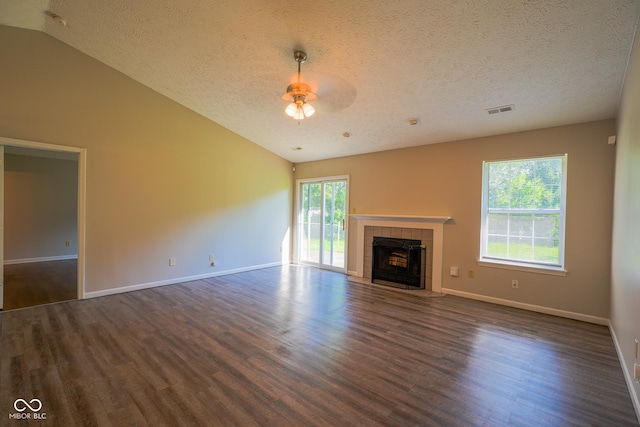 6029 Sycamore Forge Dr, Indianapolis, IN 46254 - unfurnished living room featuring vaulted ceiling, dark wood finished floors, a textured ceiling, a tile fireplace, and ceiling fan