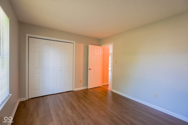 6029 Sycamore Forge Dr, Indianapolis, IN 46254 - unfurnished bedroom with dark wood finished floors, a closet, and multiple windows