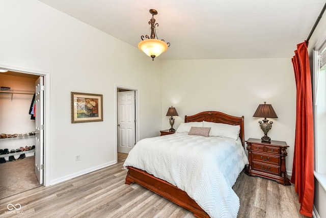 5765 White Pine Rd, Whitestown, IN 46075 - bedroom with a walk in closet, light wood-type flooring, and a closet