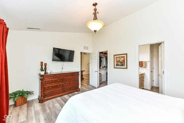 5765 White Pine Rd, Whitestown, IN 46075 - bedroom with wood finished floors, a spacious closet, high vaulted ceiling, ensuite bath, and a closet