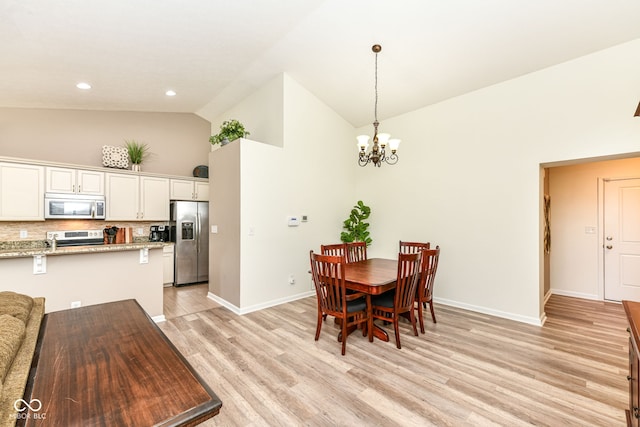 5765 White Pine Rd, Whitestown, IN 46075 - dining area featuring high vaulted ceiling, a chandelier, light wood-type flooring, and recessed lighting