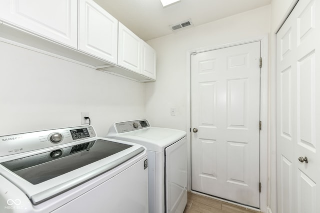 5765 White Pine Rd, Whitestown, IN 46075 - washroom with cabinet space, washer and clothes dryer, and light wood-style floors