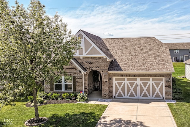 5765 White Pine Rd, Whitestown, IN 46075 - tudor-style house with brick siding, a front lawn, driveway, and a garage
