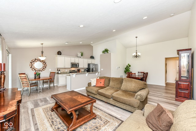 5765 White Pine Rd, Whitestown, IN 46075 - living area with lofted ceiling, light wood-style floors, recessed lighting, and a chandelier