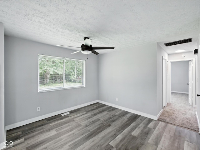 2853 S State Ave, Indianapolis, IN 46203 - unfurnished room with a ceiling fan, wood finished floors, and a textured ceiling