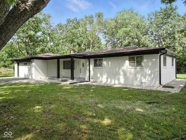 2853 S State Ave, Indianapolis, IN 46203 - view of front facade with brick siding, an attached garage, a front lawn, and a chimney