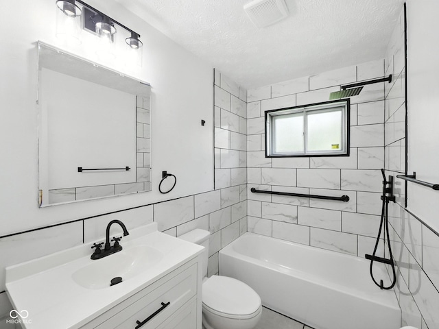 2853 S State Ave, Indianapolis, IN 46203 - full bathroom with vanity, a textured ceiling,  shower combination, and tile walls
