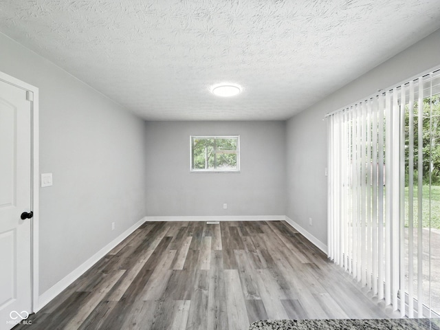 2853 S State Ave, Indianapolis, IN 46203 - empty room with wood finished floors and a textured ceiling