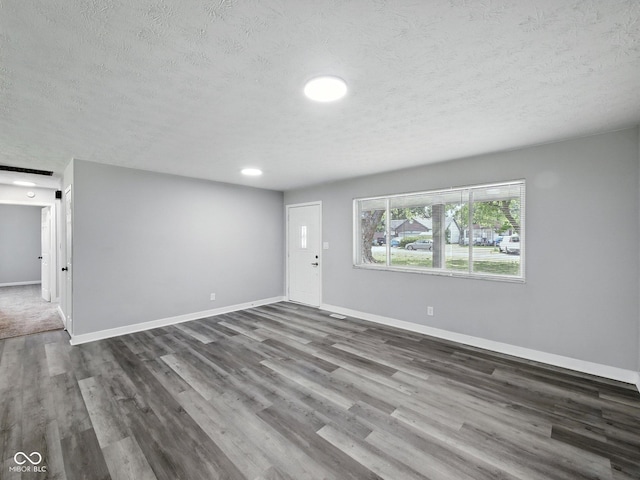 2853 S State Ave, Indianapolis, IN 46203 - unfurnished living room with a textured ceiling and wood finished floors