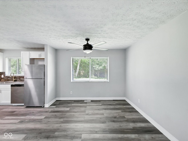 2853 S State Ave, Indianapolis, IN 46203 - unfurnished dining area featuring a ceiling fan, wood finished floors, and a textured ceiling