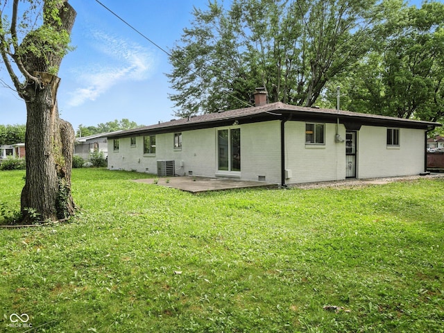 2853 S State Ave, Indianapolis, IN 46203 - rear view of property with brick siding, a chimney, a patio, and a yard